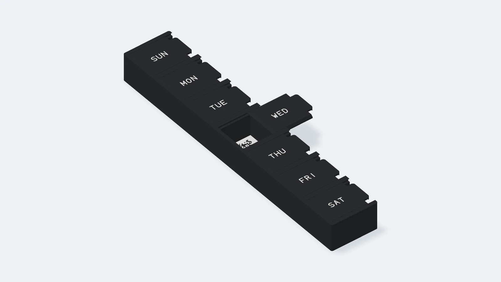 3D render of the single black Pesky Pill organizer, tilted and seen long side up: seven compartments, SUN at the far end, with black lids and white day names, the Wednesday lid slid out to the right to its stop and a black-on-white demo QR code on the compartment floor.